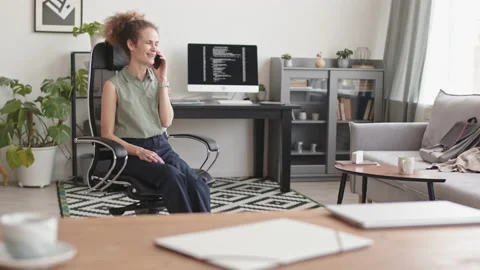 Female Programmer Talking on Phone at Home Stock Footage 171535397