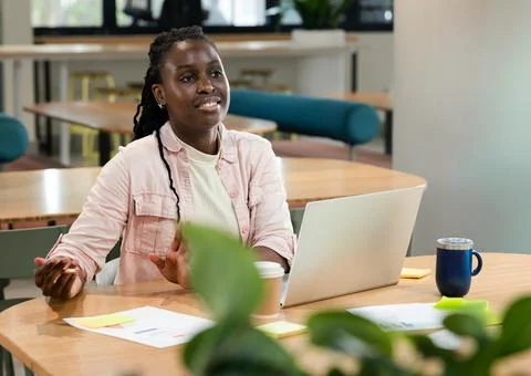 Female programmer typing code while calculating sum of array range at desk with Stock Photos