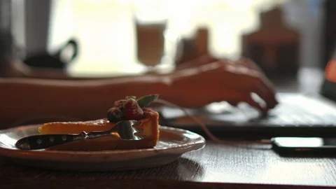 A female programmer typing source codes in a coffee shop with a relaxing working Stock Footage 99078596