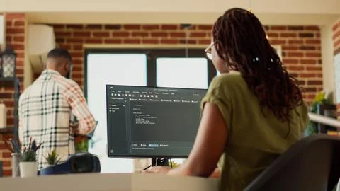 Female programmer using code to develop online app 库存照片