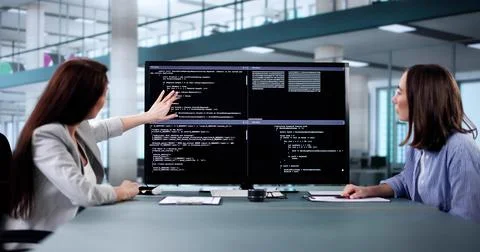 Female programmer using pair programming methodology Stock Photos
