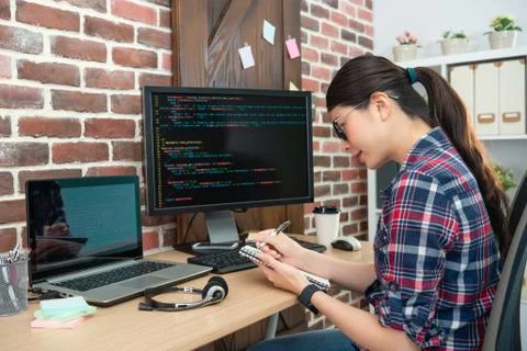 Female programmer working and writting 스톡 사진