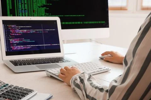 Female programmer working with computer at desk in office, closeup 스톡 사진