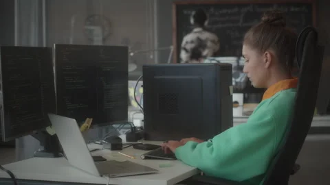 Female Programmer Working on Computer with Dual Monitor Stock Footage 263733262