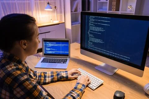 Female programmer working with computer in office at night Stock Photos