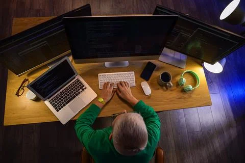 Female programmer working with computer in office at night, top view Stock Photos