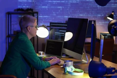 Female programmer working with computer in office at night Stock Photos