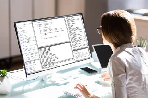 Female Programmer Working On Computer Screen Stock Photos