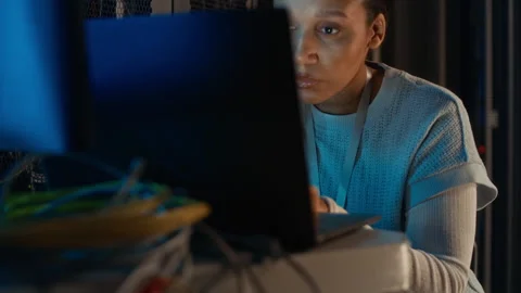 Female Programmer Working on Laptop in Data Center Stock Footage 311307898