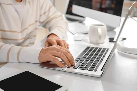 Female programmer working with laptop at desk in office, closeup Stock Photos