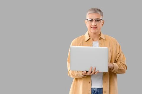 Female programmer working with laptop on light background Stock Photos