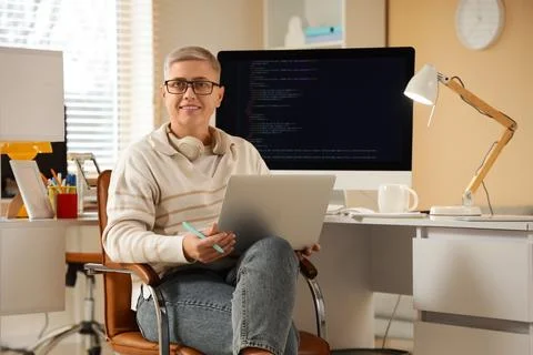 Female programmer working with laptop in office Stock-Fotos