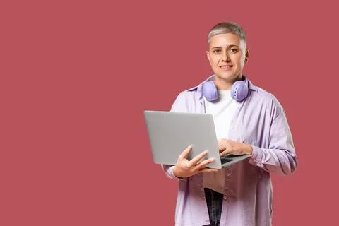 Female programmer working with laptop on red background Stock Photos