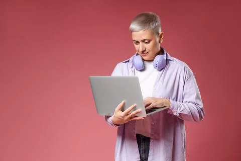 Female programmer working with laptop on red background Stock Photos