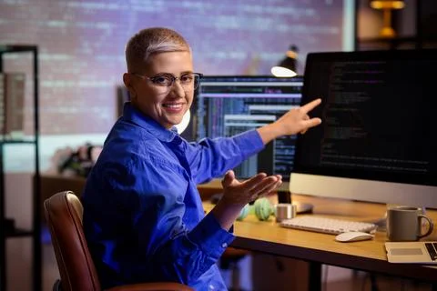 Female programmer working in office at night Stock Photos