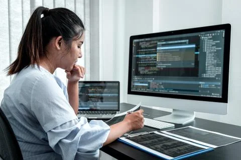 Female Programmer working in software javascript computer in IT office, Writi Stock Photos