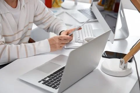 Female programmer working with tablet computer at desk in office Stock-Fotos