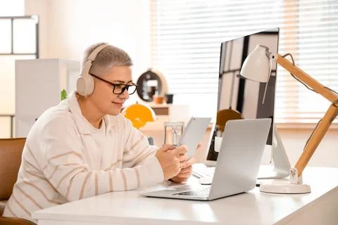 Female programmer working with tablet computer at desk in office Stock Photos