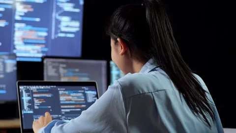 Female Programmer Writing Code Laptop Using Multiple Monitors Showing Database Stock Footage 244425082