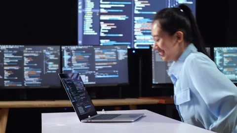 Female Programmer Writing Code Laptop Using Multiple Monitors Video stock 244427492