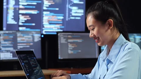 Female Programmer Writing Code Laptop Using Multiple Monitors Stock Footage 244427515