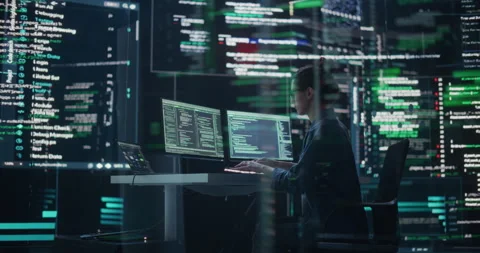 Female Programmer Writing Code Surrounded by Big Screens Video stock 243285750