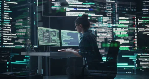 Female Programmer Writing Code Surrounded by Big Screens Video stock 243285957
