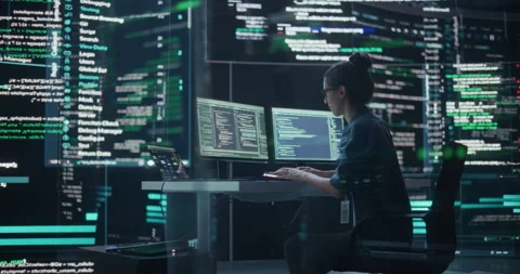 Female Programmer Writing Code Surrounded by Big Screens Video stock 243286014