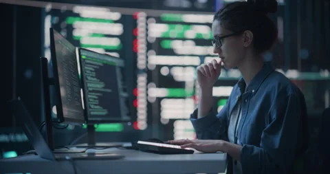 Female Programmer Writing Code Surrounded by Big Screens Stock-Footage 243286404
