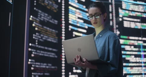 Female Programmer Writing Code Surrounded by Big Screens Video stock 243288610