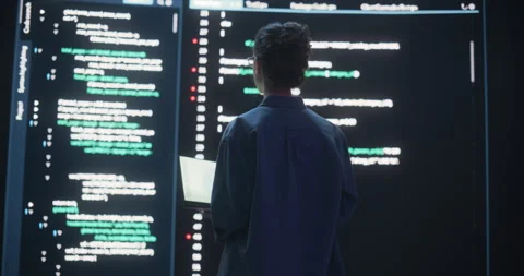 Female Programmer Writing Code Surrounded by Big Screens Stock Footage 243288635