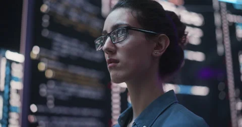 Female Programmer Writing Code Surrounded by Big Screens Stock Footage 243288841