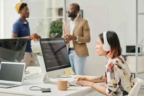 Female programmer writing codes on computer Stock Photos