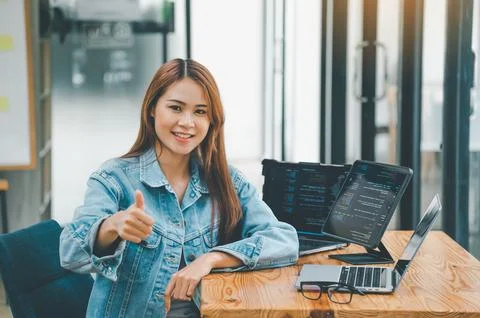 Female programmers are happily working on software coding and web designing.. 스톡 사진