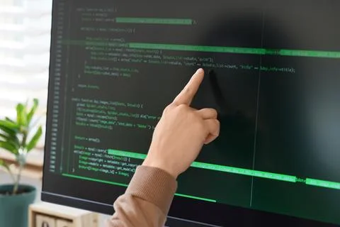 Female programmer's hand testing code on computer in office, closeup Foto stock