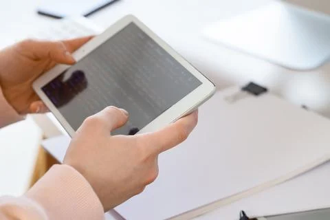 Female programmers hands testing code on tablet computer in office, closeup Foto stock
