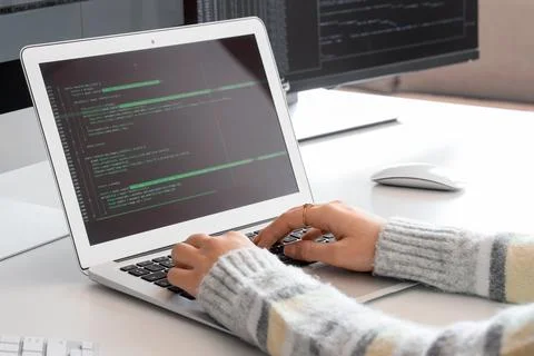 Female programmers hands working with laptop at desk in office, closeup 스톡 사진