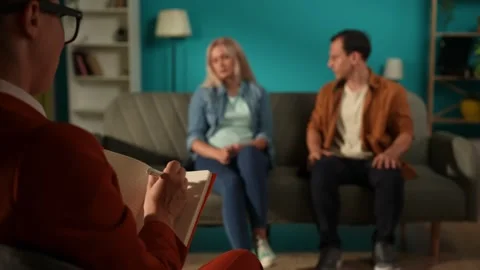 Female psychologist making notes in a notebook against the background of a Stock Footage 252400907