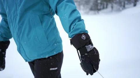 Female pulling a sledge - close up on the hand slow motion Stock Footage 104900061