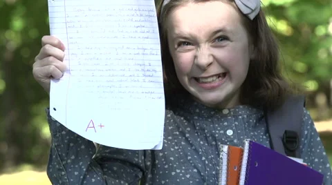 Female pupil with A+ homework Stock Footage 44101784