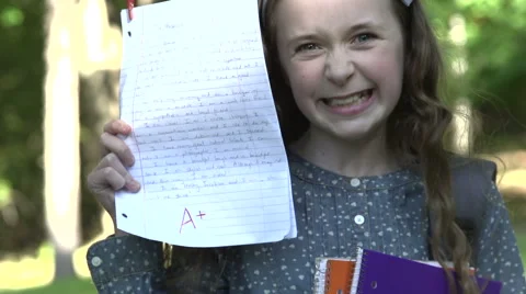 Female pupil with A+ homework Stock Footage 44101822