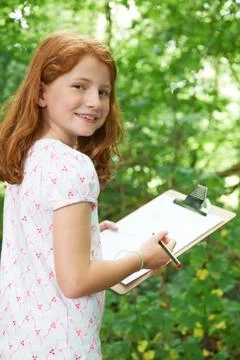 Female Pupil Making Notes On School Nature Field Trip Stock Photos