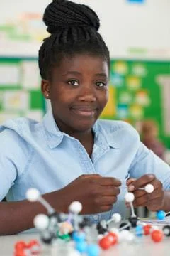 Female Pupil Using Molecular Model Kit In Science Lesson Stock Photos