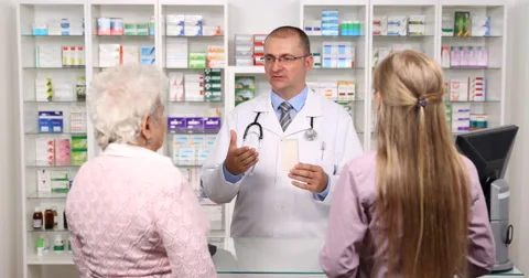 Female Purchaser Elderly and Young Women Get Assistance Helpful Pharmacist Man Stock Footage 67932399