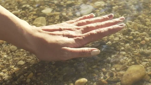 Female putting her hand under water in slow motion Stock Footage 71327182