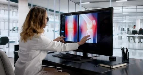 Female Radiologist Using Advanced MRI To Study Brain Injury Stock Photos