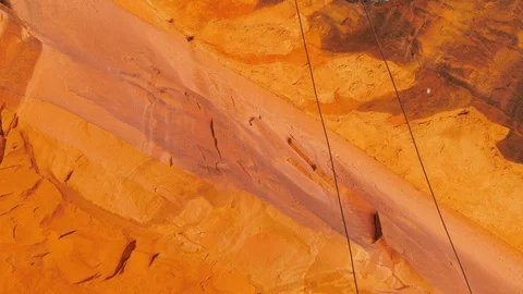 Female rappelling down sandstone. Stock Footage 89653943