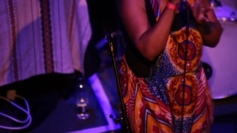 Female rapper preforms on stage in ankara dungarees	 Stock-Footage 98743216