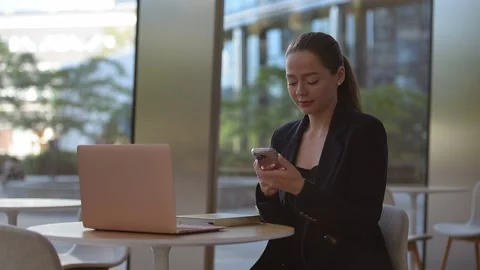 A female realtor in a blazer is having a conversation on the cell phone. Stock Footage 203601351