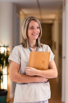 Female receptionist holding folder with documents in hospital Stock Photos